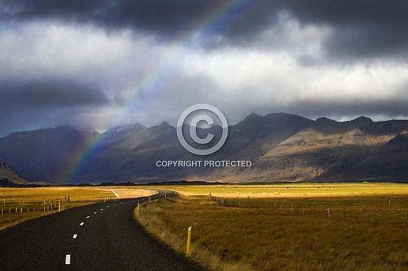Rainbow over a rural road - Iceland
