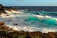 Waves crashing coastal secene