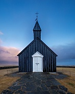 Black church in Iceland at sunset