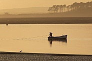 Fisherman hauling in his nets - Caernarfon - Wales