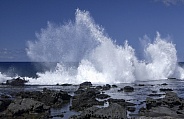 Waves splashing on coastal rocks