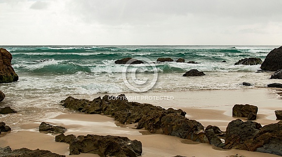 Waves crashing against rocks.
